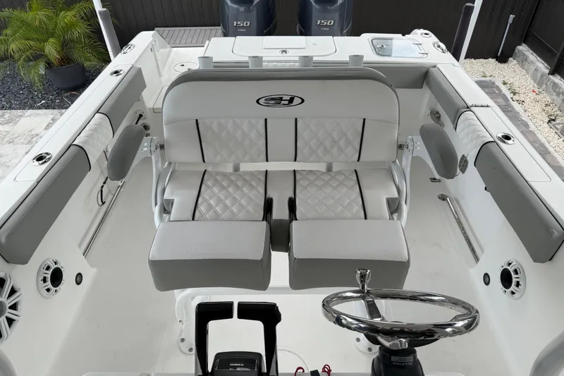Slide: The Image of 2016 Sea Hunt Gamefish 25 boat interior with dual seats and steering wheel. - 11