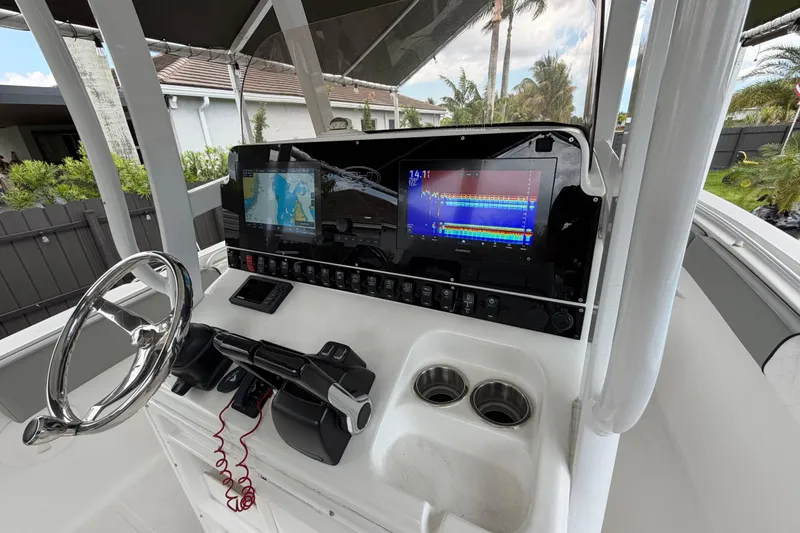 Slide: The Image of 2016 Sea Hunt Gamefish 25 boat dashboard with navigation and control systems. - 15