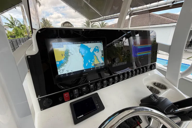 Slide: The Image of 2016 Sea Hunt Gamefish 25 dashboard with navigation and control systems. - 16