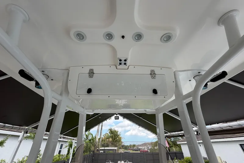 Slide: The Image of 2016 Sea Hunt Gamefish 25 T-top interior with rod holders and overhead lights. - 20