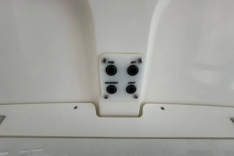 Slide: The Image of Control panel on a 2016 Sea Hunt Gamefish 25 boat, featuring labeled buttons. - 21