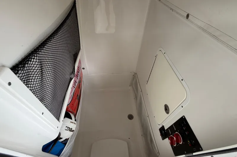 Slide: The Image of Interior storage compartment of a 2016 Sea Hunt Gamefish 25 boat with netting and control panel. - 24