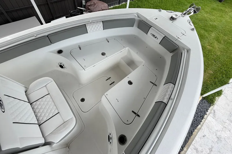 Slide: The Image of 2016 Sea Hunt Gamefish 25 boat interior with seating and storage compartments. - 27