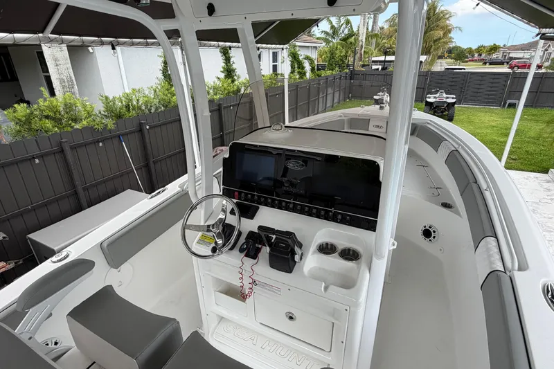 Slide: The Image of 2016 Sea Hunt Gamefish 25 boat interior with steering console and seating. - 36