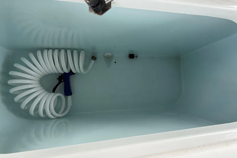 Slide: The Image of Livewell with coiled hose in 2016 Sea Hunt Gamefish 25 boat. - 43