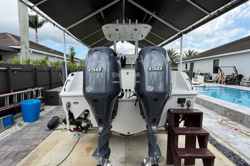 Slide: The Image of 2016 Sea Hunt Gamefish 25 with twin Yamaha 150 engines, parked near a pool. - 5