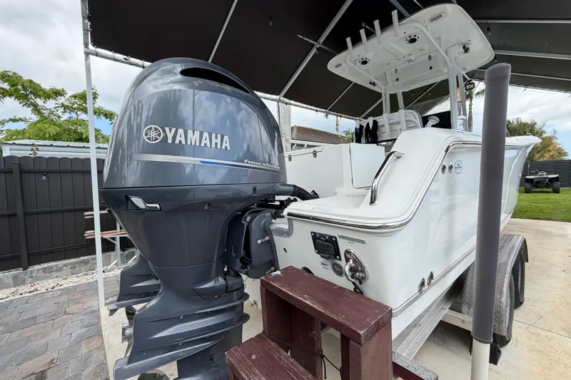 Slide: The Image of 2016 Sea Hunt Gamefish 25 boat with Yamaha outboard motor on trailer. - 7