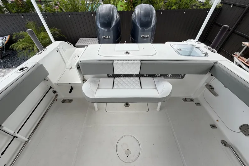 Slide: The Image of 2016 Sea Hunt Gamefish 25 boat interior with dual 150 engines and seating area. - 8