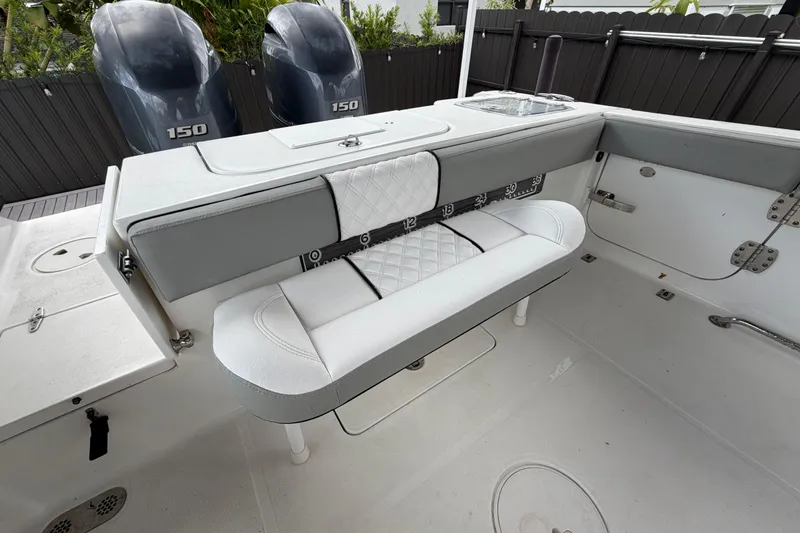 Slide: The Image of 2016 Sea Hunt Gamefish 25 boat interior with dual 150 engines and cushioned seating. - 9