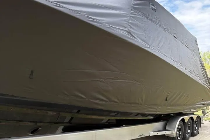Slide: The Image of 2022 Nor-Tech 390 Sport Center Console boat covered on a trailer. - 10