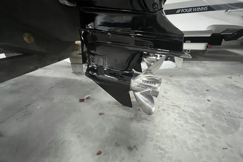 Slide: The Image of 2017 Scout 320 LXF boat with Yamaha propeller in a garage setting. - 11