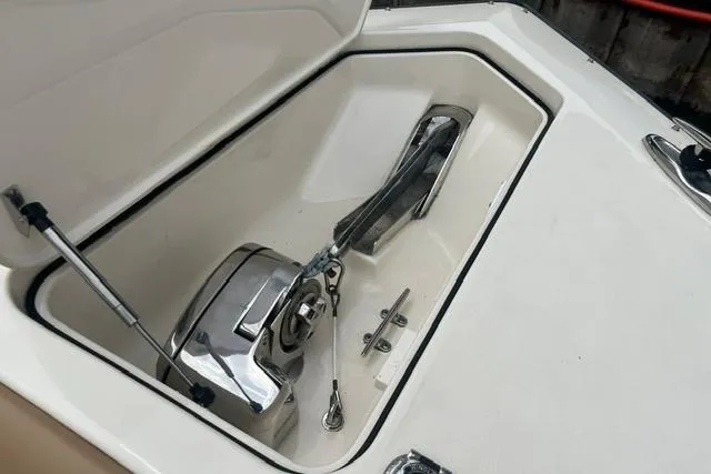 Slide: The Image of Anchor compartment of 2017 Scout 320 LXF boat, featuring a polished anchor winch. - 21