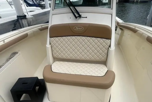Slide: The Image of 2017 Scout 320 LXF boat with tan and white quilted seating. - 22