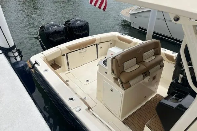 Slide: The Image of 2017 Scout 320 LXF boat with dual engines, docked on calm water. - 23