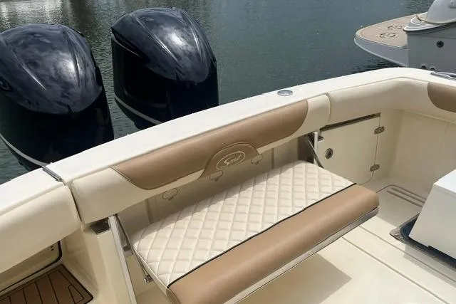 Slide: The Image of 2017 Scout 320 LXF boat with cushioned seating and dual outboard motors. - 26
