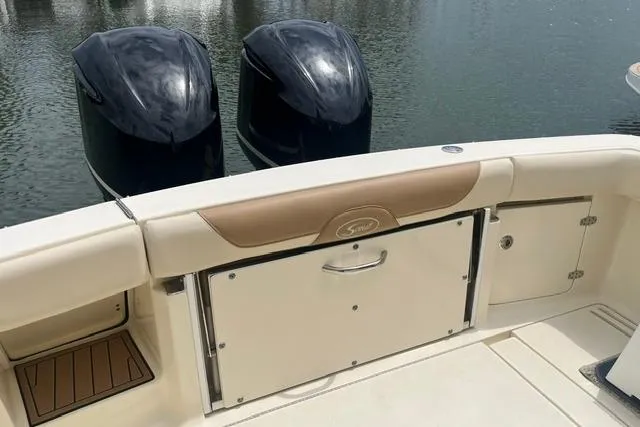 Slide: The Image of 2017 Scout 320 LXF boat with dual outboard motors on calm water. - 27