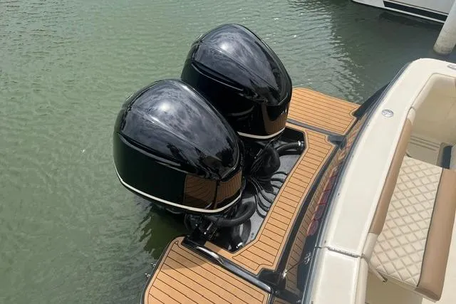 Slide: The Image of 2017 Scout 320 LXF boat with dual outboard motors on teak deck. - 29