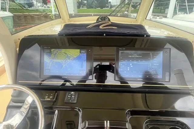 Slide: The Image of Dashboard of a 2017 Scout 320 LXF boat with dual navigation screens. - 36