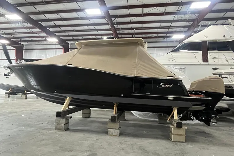 Slide: The Image of 2017 Scout 320 LXF boat in storage, covered, indoors, on blocks. - 4