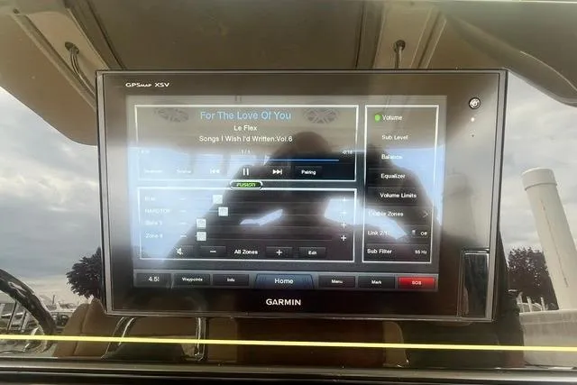 Slide: The Image of Garmin display on 2017 Scout 320 LXF boat showing music controls and settings. - 40