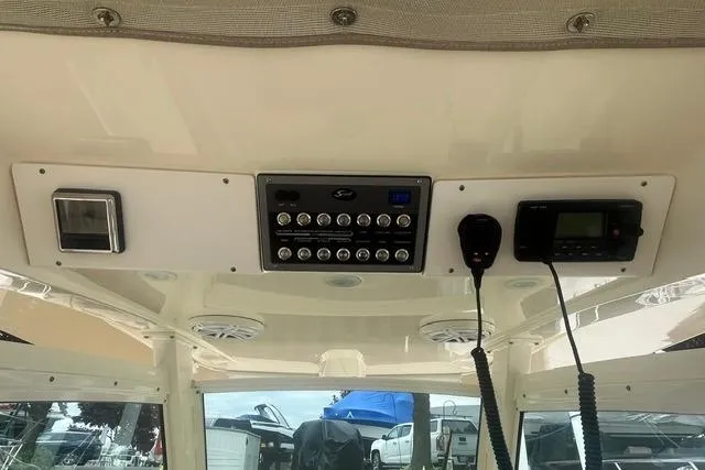 Slide: The Image of 2017 Scout 320 LXF boat dashboard with control panel and communication devices. - 44