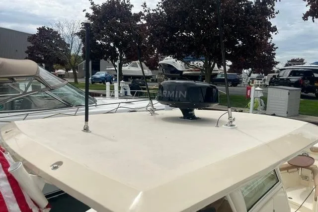Slide: The Image of 2017 Scout 320 LXF boat with Garmin radar, docked near other vessels. - 47