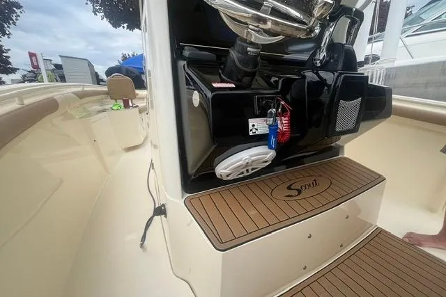 Slide: The Image of 2017 Scout 320 LXF boat interior with teak flooring and control panel. - 48