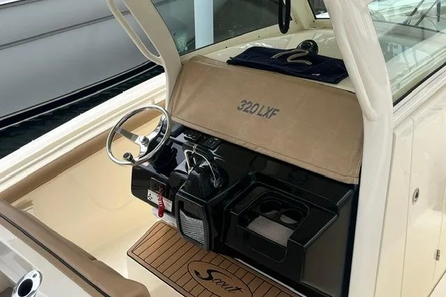 Slide: The Image of 2017 Scout 320 LXF boat interior with steering wheel and dashboard. - 49