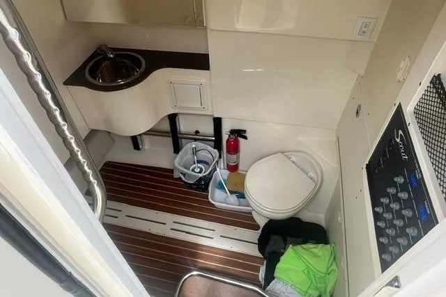Slide: The Image of 2017 Scout 320 LXF boat bathroom with sink, toilet, and wooden floor. - 50