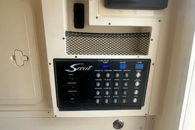 Slide: The Image of Control panel of a 2017 Scout 320 LXF boat with various switches and displays. - 51