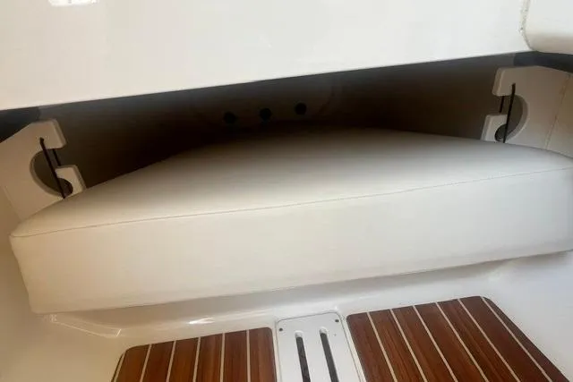 Slide: The Image of 2017 Scout 320 LXF boat interior with cushioned seating and wooden flooring. - 54