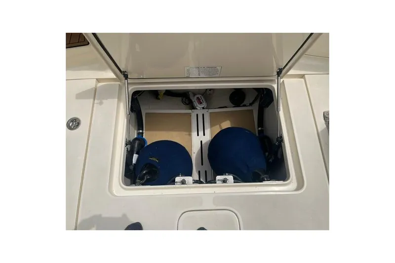 Slide: The Image of Open storage compartment on a 2017 Scout 320 LXF boat, showcasing interior components. - 59