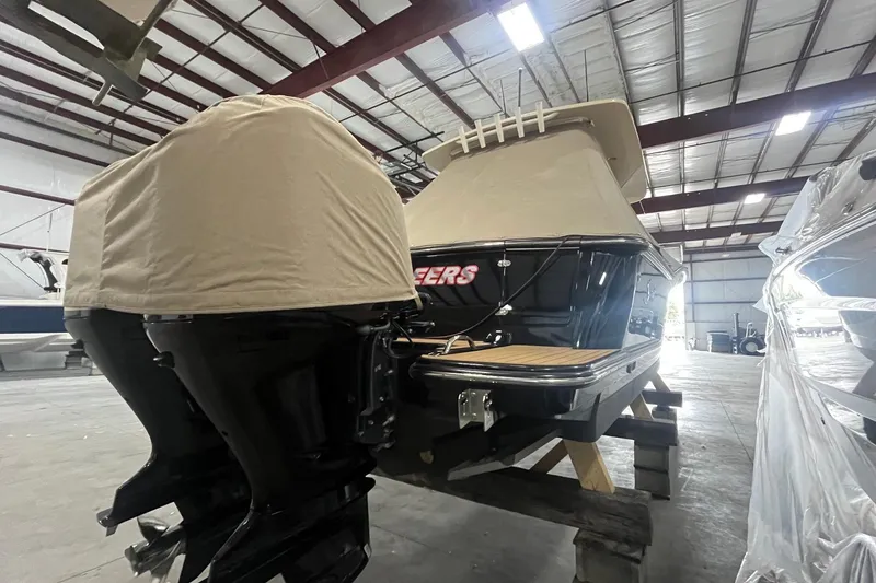Slide: The Image of 2017 Scout 320 LXF boat in storage, covered engines, indoor facility. - 8