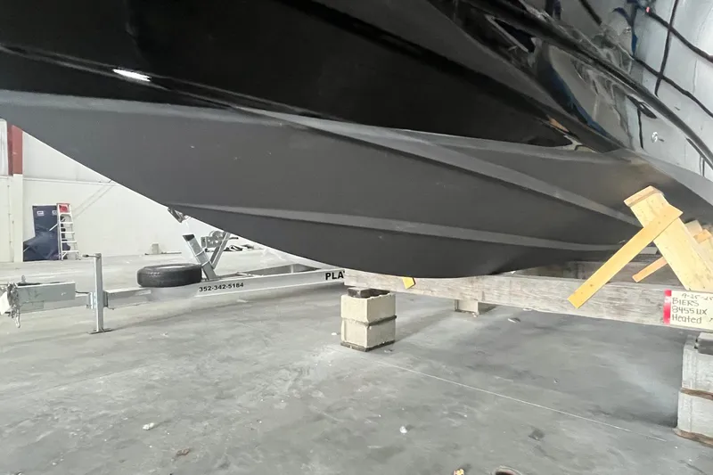 Slide: The Image of 2017 Scout 320 LXF boat hull on trailer in storage facility. - 9