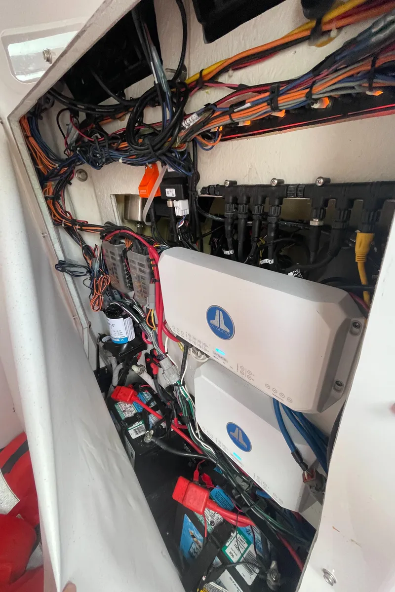 Slide: The Image of Electrical wiring and components inside a 2022 Sportsman Masters 247OE Bay Boat. - 22