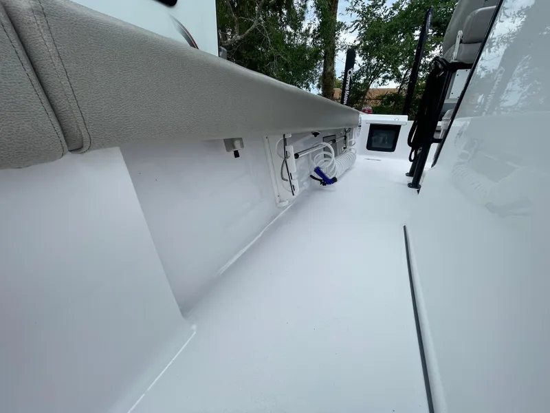 Slide: The Image of 2022 Sportsman Masters 247OE Bay Boat interior with clean white deck and storage compartments. - 8