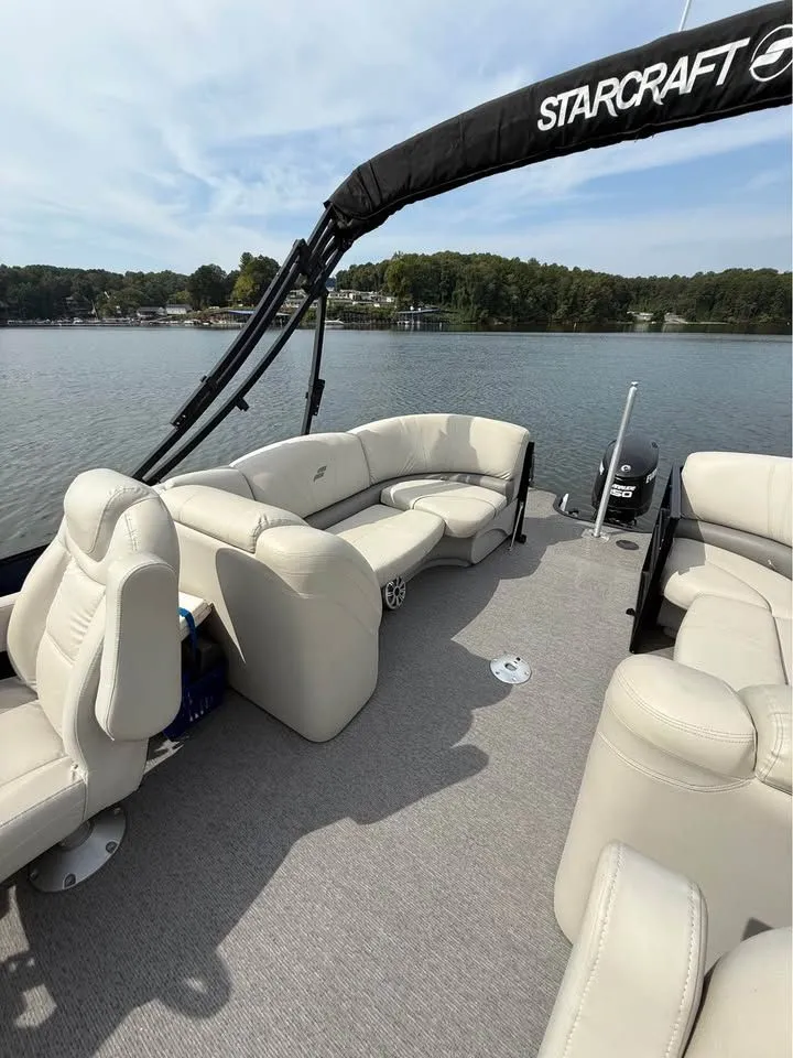 Slide: The Image of 2018 Starcraft SLS-3 pontoon boat on a calm lake. - 11