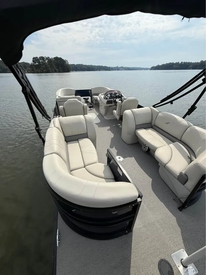 Slide: The Image of 2018 Starcraft SLS-3 pontoon boat on a calm lake. - 9