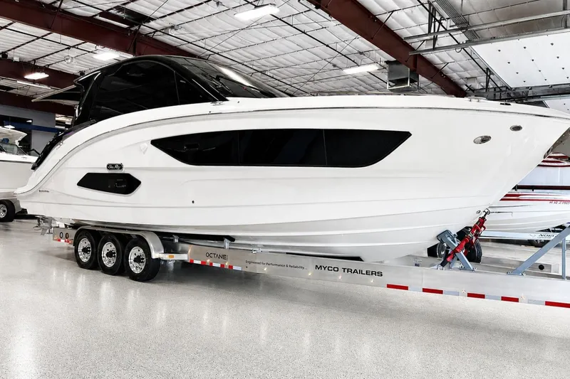 The Image of 2025 Sea Ray Sundancer 370 Outboard on trailer in indoor showroom. - 0