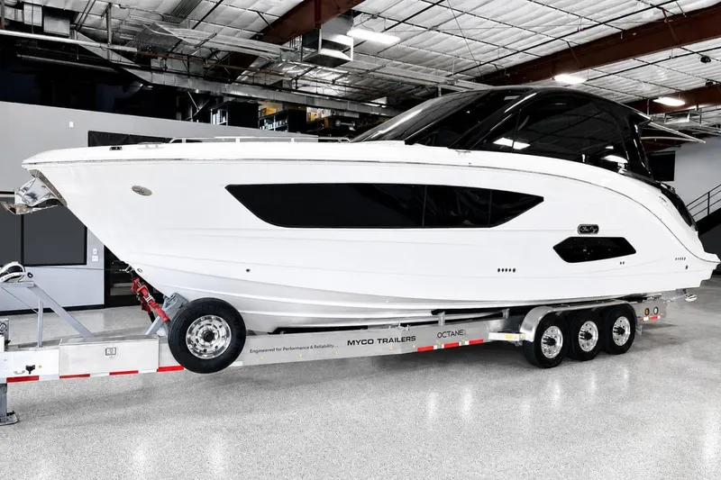 Slide: The Image of 2025 Sea Ray Sundancer 370 Outboard on trailer in indoor showroom. - 1