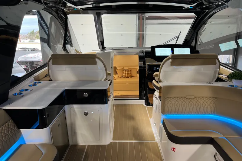 Slide: The Image of Interior of 2025 Sea Ray Sundancer 370 Outboard, featuring luxurious seating and modern controls. - 12