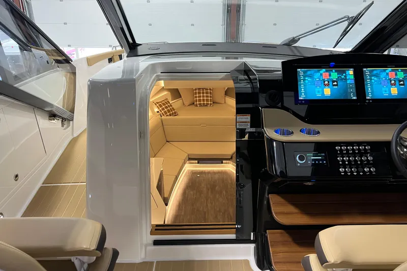 Slide: The Image of Interior view of 2025 Sea Ray Sundancer 370 Outboard, featuring modern helm and cozy cabin. - 14