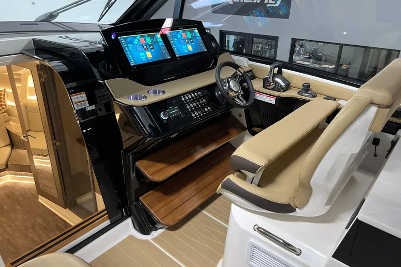 Slide: The Image of 2025 Sea Ray Sundancer 370 Outboard helm with dual screens and luxurious seating. - 15