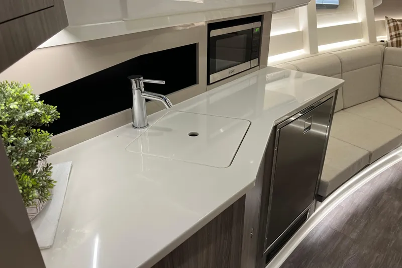 Slide: The Image of Modern kitchen area in 2025 Sea Ray Sundancer 370 Outboard yacht, featuring sleek countertop and appliances. - 17