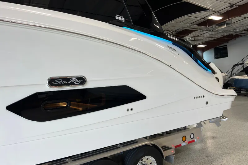 Slide: The Image of 2025 Sea Ray Sundancer 370 Outboard boat in showroom, side view. - 2