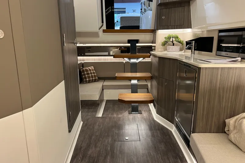 Slide: The Image of Luxurious interior of 2025 Sea Ray Sundancer 370 Outboard yacht with modern kitchen and seating area. - 20