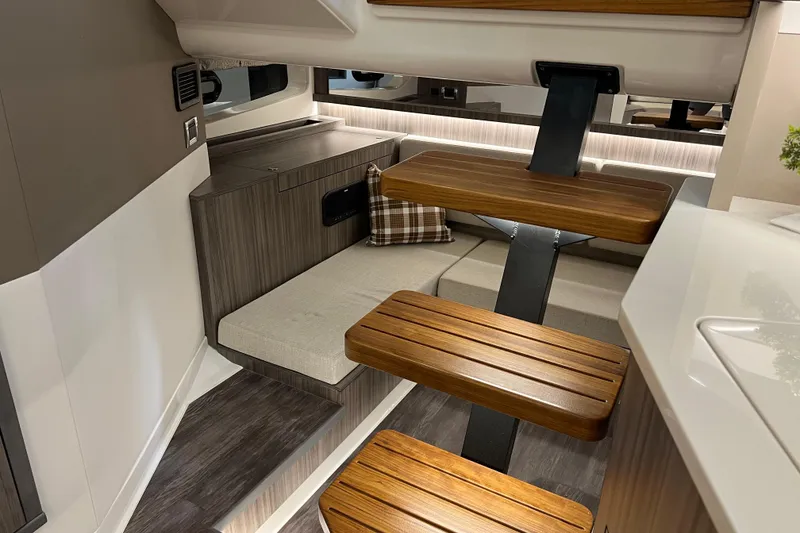 Slide: The Image of Interior of 2025 Sea Ray Sundancer 370 Outboard, featuring modern wood accents and cozy seating. - 21