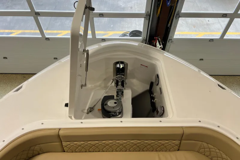 Slide: The Image of 2025 Sea Ray Sundancer 370 Outboard bow area with anchor storage and beige seating. - 25