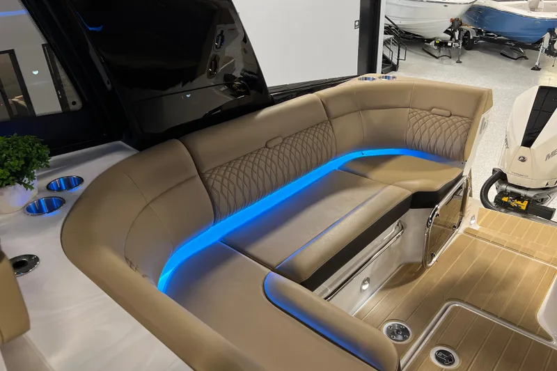 Slide: The Image of Luxurious seating area on 2025 Sea Ray Sundancer 370 Outboard with ambient blue lighting. - 31