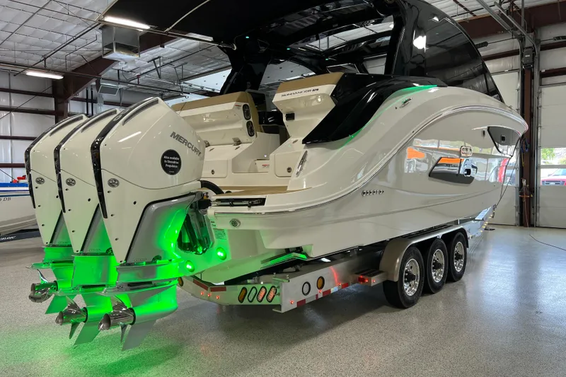 Slide: The Image of 2025 Sea Ray Sundancer 370 Outboard with triple Mercury engines in a showroom. - 33